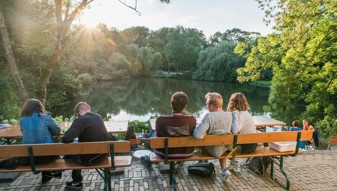 People sitting at terrace at 't Nieuwe Diep in Flevopark drinking jenever