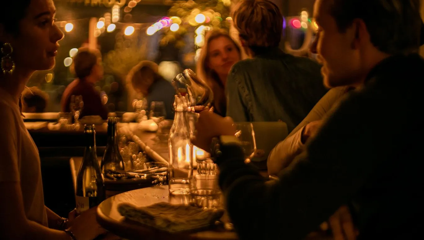 People sitting at the bar at Compartir wine bar and restaurant on Spaarndammerstraat