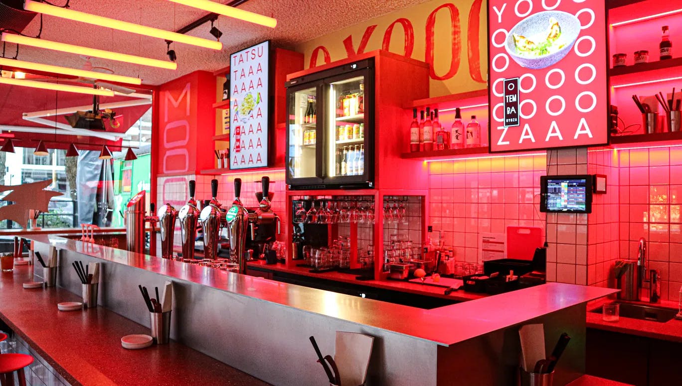 Pink neon interiors of OTEMBA-gyoza Japanese restaurant on Van Woustraat in De Pijp