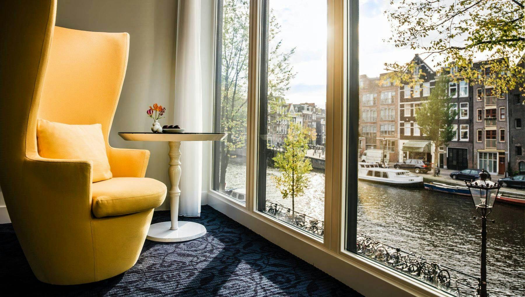 Chair at the window in hotel Andaz with view on the Prinsengracht.
