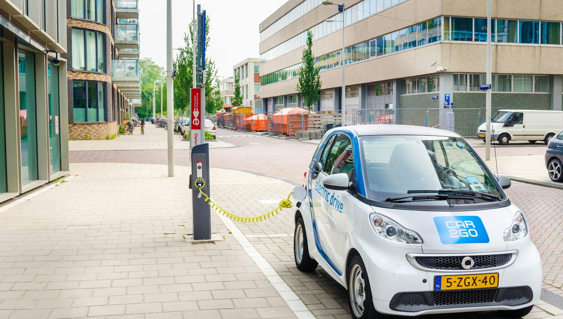 Amsterdam, The Netherlands - June 12, 2016: Car2Go Electric Car being Charged. Car2go is carsharing service available in Europe and North America. The Cars are user-accessed via a smartphone app