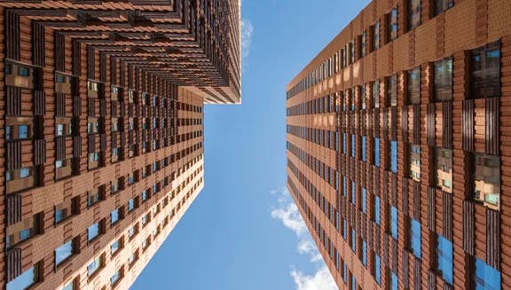 Zuidas architecture, tall building under a blue sky.