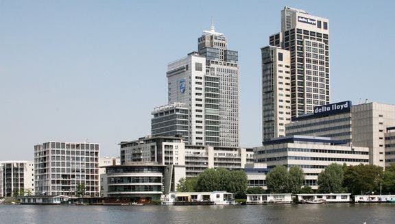Office buildings on the banks of a river.