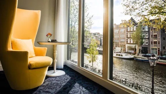Chair at the window in hotel Andaz with view on the Prinsengracht.