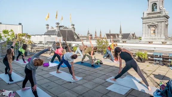 Upon the roof yoga session on De Bijenkorf, a luxury department store. 24H Centrum.