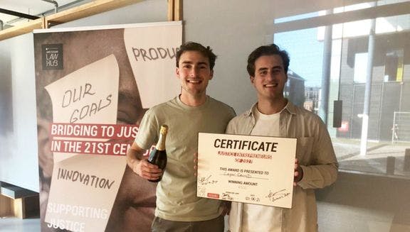 LegalCrowd co-founders Gabriel Poltorak and Joost Jansen holding a certificate for being "Justice Entrepreneurs of 2021"