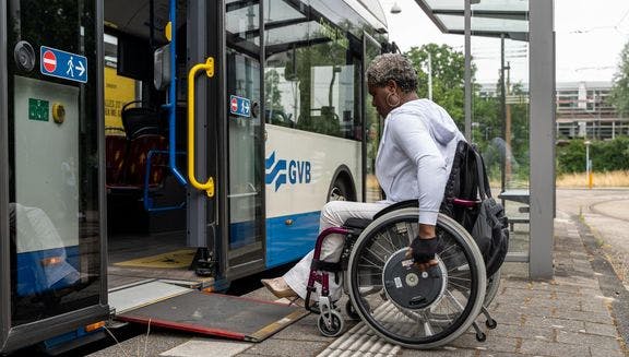 A person in a wheelchair enters the bus.