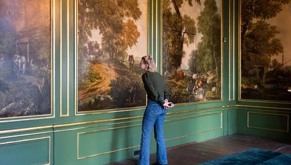 Grachtenmuseum inside, person watching painting