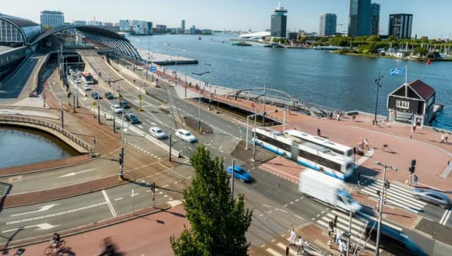 IJ and Amsterdam Centraal Train Station.