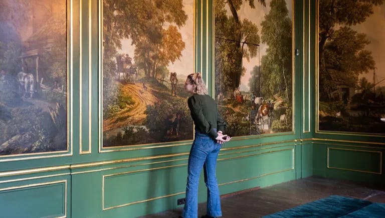Grachtenmuseum inside, person watching painting