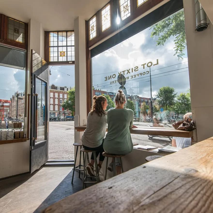 People looking out the window at Lot Sixty One Lot 61 coffee bar on the Kinkerstraat