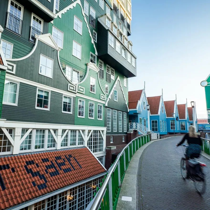 People cycling next to the iconic Zaan hotel in Zaandam