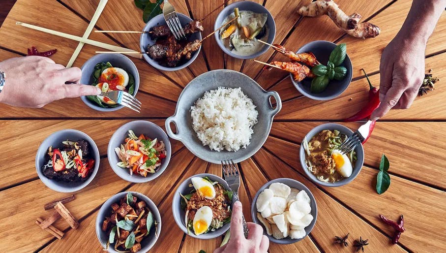 Assortment of plates with Indonesian food.