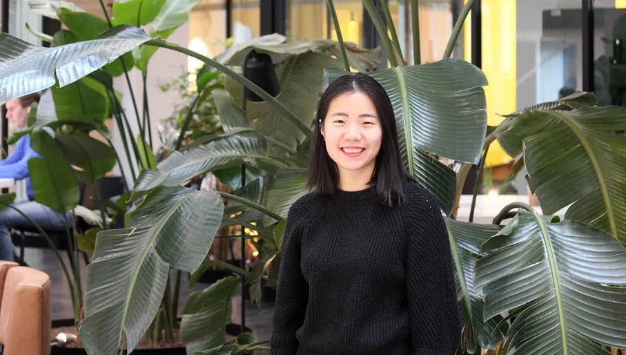 Portrait of Grip Fertility co-founder Ling Lin in front of a large plant.