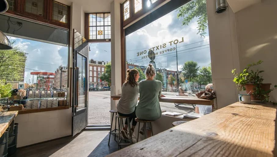 People looking out the window at Lot Sixty One Lot 61 coffee bar on the Kinkerstraat
