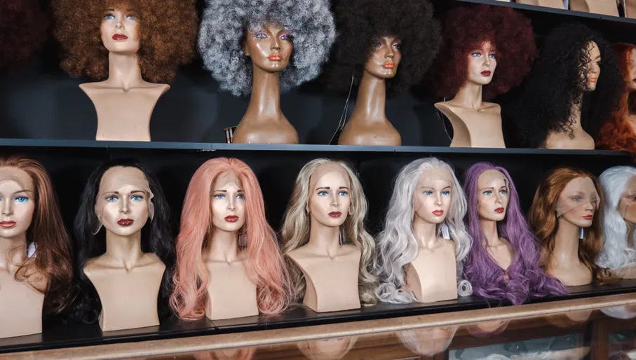 Selection of wigs in the interior of Back Stage hair and beauty store.