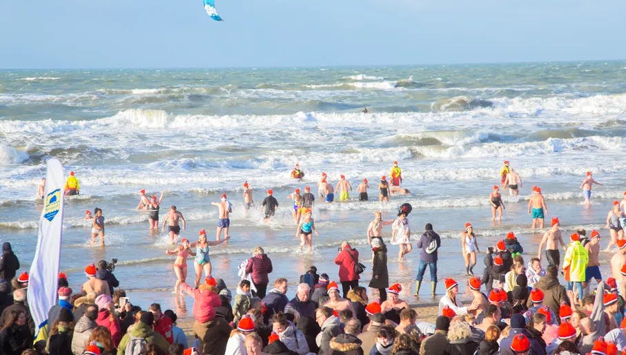 January 1, 2019, Zandvoort, North Holland, the Netherlands. Traditional Dutch New Year's diving in the sea. People gather on the beach and all run to swim in the sea.