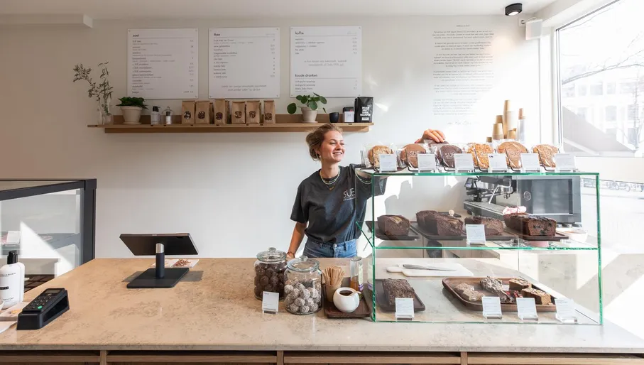 Woman serving pastries at SUE Bites Bar