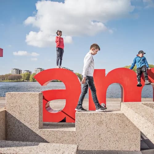 Kids climbing on the I amsterdam letters near Sloterplas, Sloterpark.